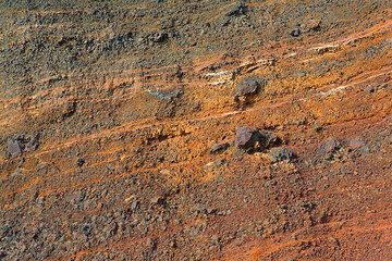 Layers of red scoria lapilli and bombs exposed at the red beach (Photo: Tom Pfeiffer)