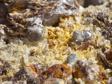 Galenite crystals sitting on Quartz crystals. The Galenite is mostly covered by Cerusite. (Photo: Tobias Schorr)