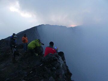 Day 3 - Sitting on the crater rim waiting for the clouds and volcanic gasses to lift for a first view into the caldera (Photo: Ingrid Smet)