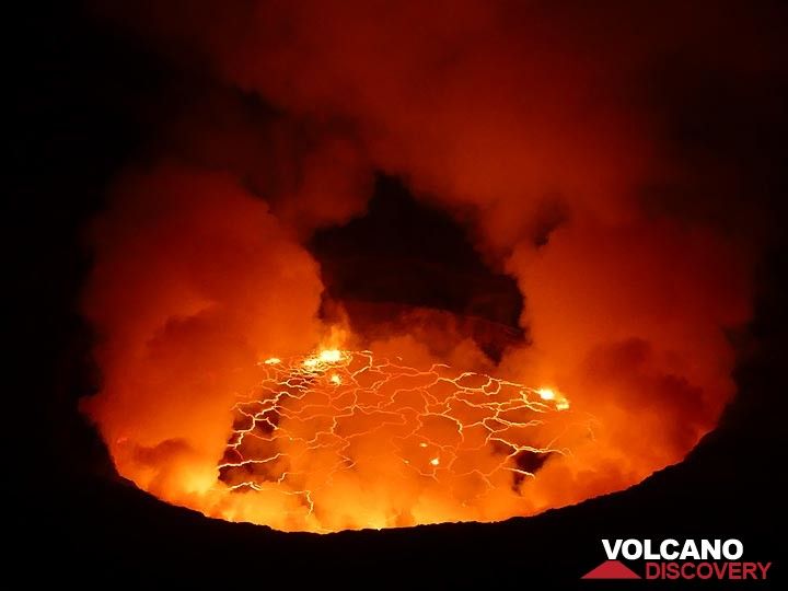 Day 3 - As the view inside the caldera becomes more clear we can see the red glow of the active lava lake reflecting in the volcanic gasses above (Photo: Ingrid Smet)