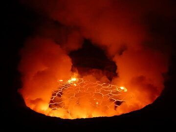 Day 3 - As the view inside the caldera becomes more clear we can see the red glow of the active lava lake reflecting in the volcanic gasses above (Photo: Ingrid Smet)