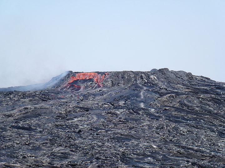 The lava lake was extremely active when our group visited it during the second half of November 2016, overflowing its newly constructed containment ring a number of times each day - this picture clearly illustrates how it is now a perched lava lake. (Photo: Hans and Jooske)