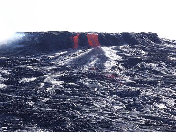 New lava is supplied from the active lava lake into pahoehoe lava flows that formed during an earlier overflow. (Photo: Hans and Jooske)