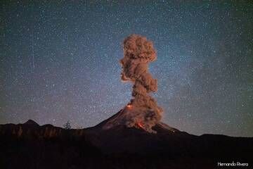 Colima volcano in Mexico during an intense eruptive phase: while several lava flows descend the southern and western flanks, fed by the summit lava dome, a pyroclastic flow caused by collapsing lava from one of the flows produces a dense ash cloud that rises approx. 2 km.
A meteorite falls from the sky above the scene. (Photo: Hernando Rivera)