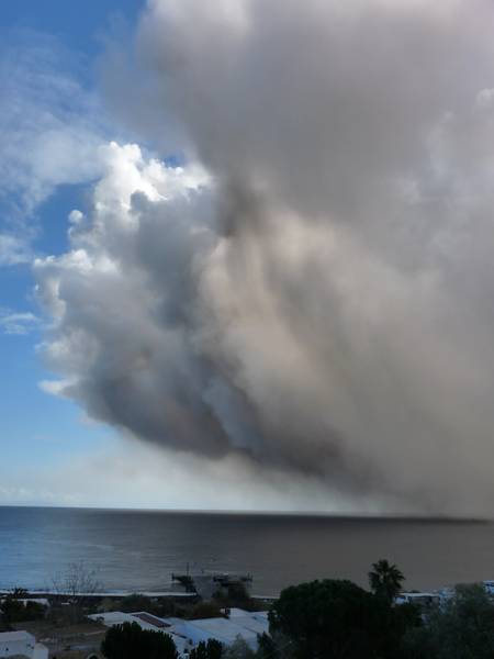 Unusually large ash cloud from Stromboli volcano drifting out onto the sea. On the 12th of January 2013, around midday, a large explosion from the NE vent triggered a partial collapse of its crater rim which evoked a very large ash cloud and brought unrest amongst Stromboli's inhabitants. (Photo: Ingrid)