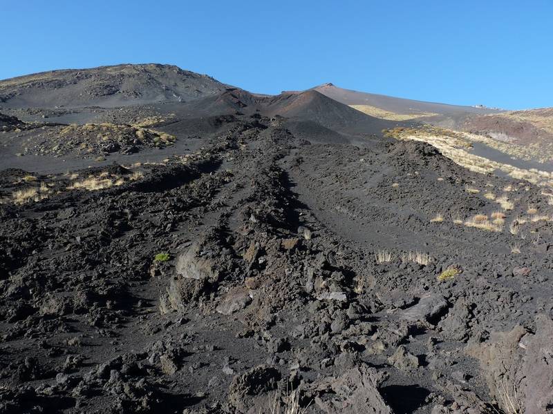 One of the many eruption cones on Etna's flanks, with a lava channel emerging from it in the foreground. Italy's Volcanoes: The Grand Tour, October 2013 (Photo: Ingrid)