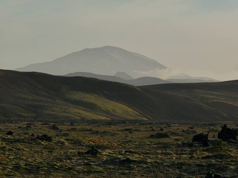 The contours of Mount Hekla materialising in the hazy evening light behind a volcanic ridge. Near  Hrauneyjalón, southern boundary of the Icelandic Highlands - 13 Septmeber 2014. (Photo: Ingrid)