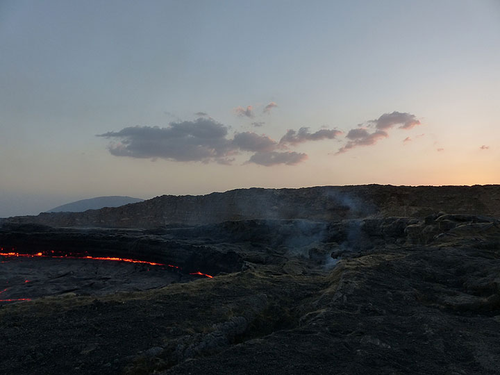 DAYS 5-6-7: Erta Ale - The active lava lake at dusk with the outer caldera rim in the background. (Photo: Ingrid)