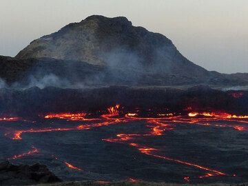 DAYS 5-6-7: Erta Ale - As the daylight slowly fades away, the red-hot glow along the edges and zigzag cracks of the lava lake become more visible. (Photo: Ingrid)