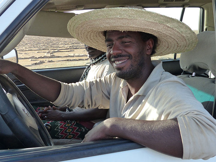 DAY 10: Lake Assale - Our driver, Tsegay, showing off the handmade sun had bought from a local Afar woman (Photo: Ingrid)
