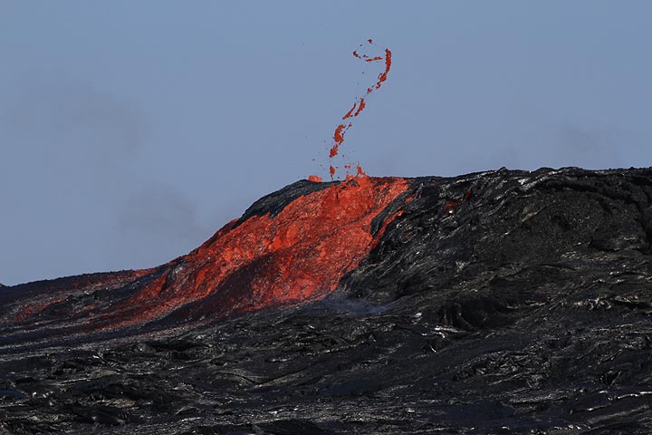 A string of lava is thrown into the air as a larger gas bubble explodes while lava is surging out from the bowl. 
"We were observing 20-30 m fountains splashing on the norther side of the wall." (Enku) (Photo: Paul Reichert)