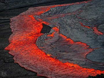 The lava lake's black crust is continuously renewed when liquid lava from below overflows and recycles it (Erta Ale fissure eruption) (c)