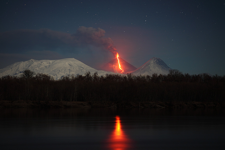 Moonlit view of Kliuchevskoi erupting with reflection in Kamchatka River. Plosky massive is to left, Kamen to right. (Photo: Richard Roscoe)