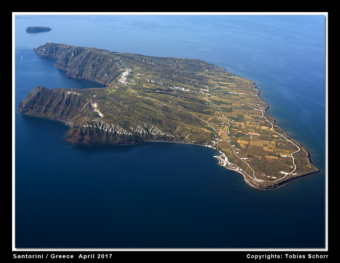 Aerial view of the small island of Thirasia, which forms the western part of the Santorini caldera rim. View is from the north. The gently dipping western flanks (r), formed by pumice plains, is in stark contrast to the steep caldera cliffs (l) up to 300 m high.  (Photo: Tobias Schorr)