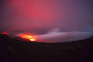 Gewitter sind über dem Ambrym keine Seltenheit. Hier werden nächtliche Regenwolken über den Kratern von der Lava angeleuchtet. (Photo: Tom Pfeiffer)