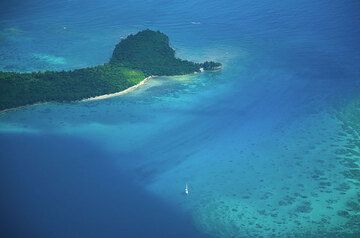 Coral sea between Epi Island (above in picture) and Tongoa Island. (Photo: Tom Pfeiffer)