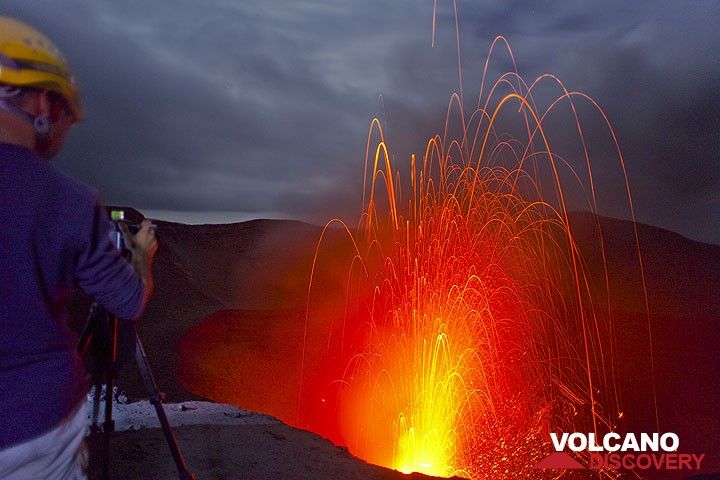 Photographer filming Yasur volcano in the evening. (Photo: Tom Pfeiffer)