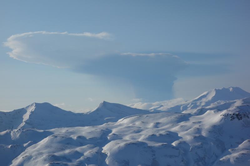 February 19 Bogoslof eruption plume as seen from Unalaska Island, 53 miles ESE of Bogoslof volcano. Photo taken from helicopter during fieldwork by AVO geologists at 5:22PM, approximately 14 minutes after the start of the eruption. (image: Janet Schaefer / AVO)