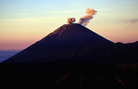 Erupting Semeru volcano seen at sunrise.