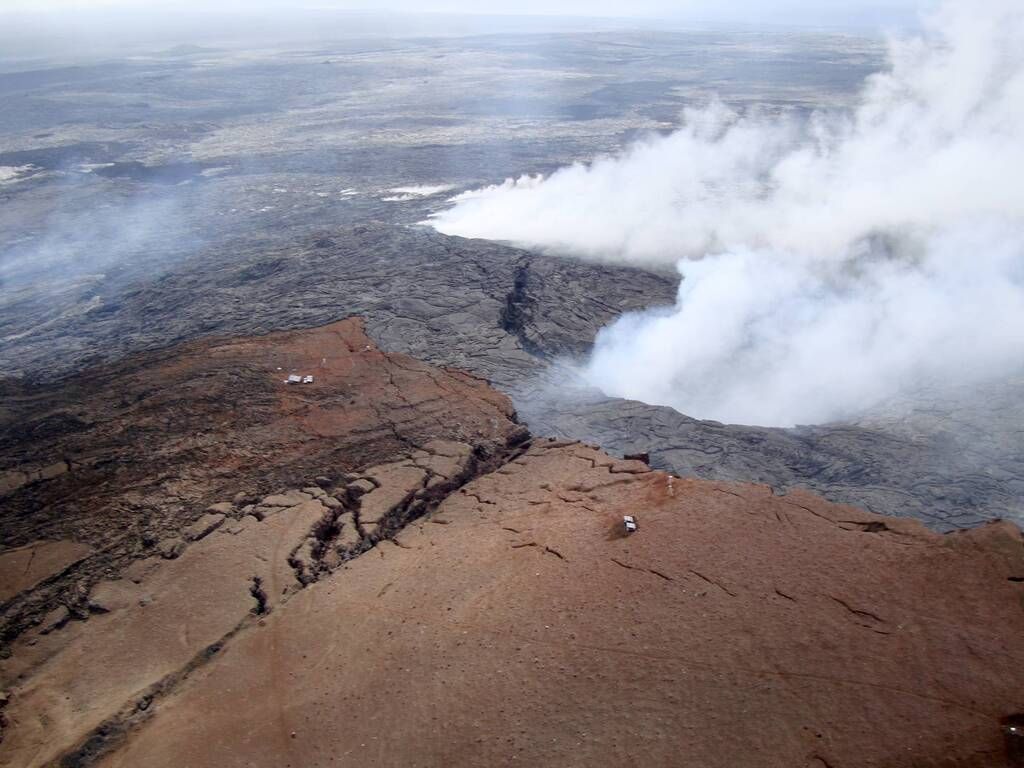 Since the onset of the "June 27 breakout" flow, the central part of Puʻu ʻŌʻō's crater has been collapsing slowly. Thick fume and steam prevented good views, but this photo shows the edge of the ring fracture that bounds the collapse. The heavy fume comes from pits that formed where spatter cones used to be.