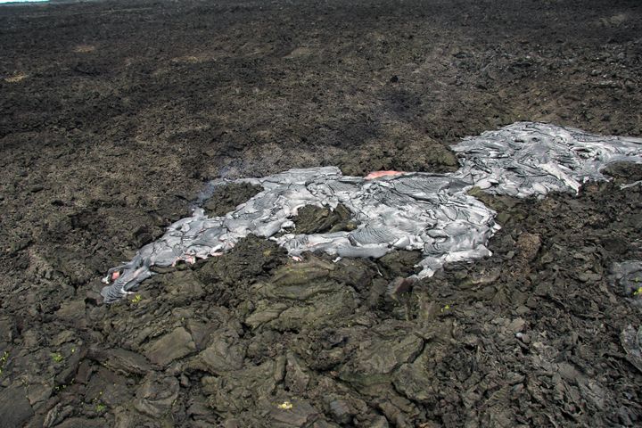 Portions of the June 27 lava flow continue to expand and cover older flows from Puʻu ʻŌʻō.