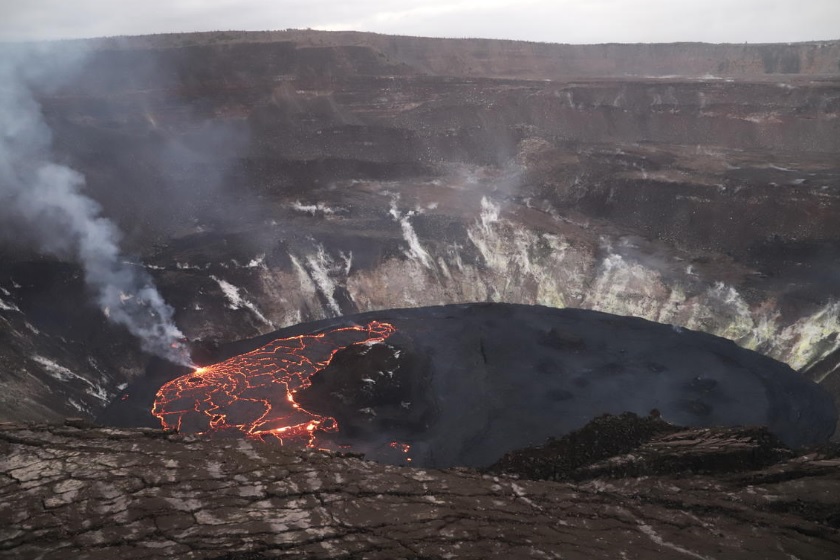 Picture shows the active western (left) portion of the lava lake, which has hot incandescent lava visible at boundaries between plates on the lava lake. The inactive eastern (right) portion of the lake appears dark (image: HVO)