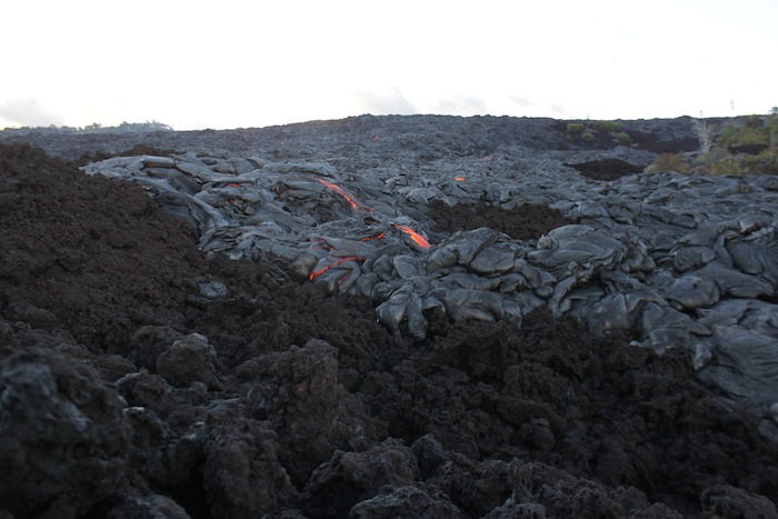 Active pahoehoe lava crossing an older ‘ā‘ā flow near the base of the pali on June 30, 2012.
