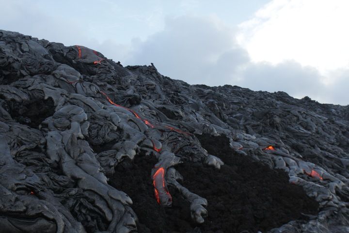 Lava flows from the Peace Day Fissure make their way down the final slope before reaching Kīlauea volcano's coastal plain on March 2, 2012.