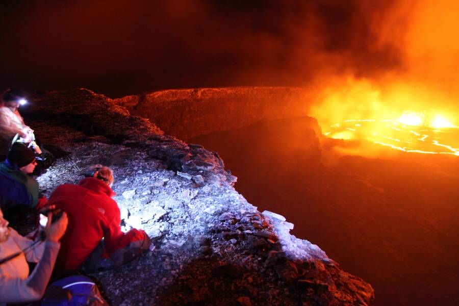 I took this photo in the middle of the night at the edge of the Puu Oo volcano crater, admiring the boiling lava lake, Kilauea Volcano in Hawaii, US.