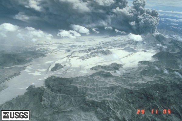 The June 29, 1991 eruption column from Mount Pinatubo with Marella River Valley. Aerial view to north of pyroclastic-flow deposits in Marella River valley (in foreground) and tributaries of Balin Buquero River (in distance) with ash plume rising from Pinatubo’s caldera. Pyroclastic-flow deposits to east of isolated hill in right center as about 200 meters thick. Dark streaks on pyroclastic-flow deposits are lahar deposits generated by rains. U.S. Geological Survey Photograph taken on June 29, 1991, by Ed Wolfe.