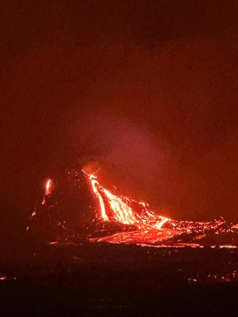 Incandescent fluid lava flows from the hornito in the southern pit crater on 13 October (image: Enku Mulugeta)