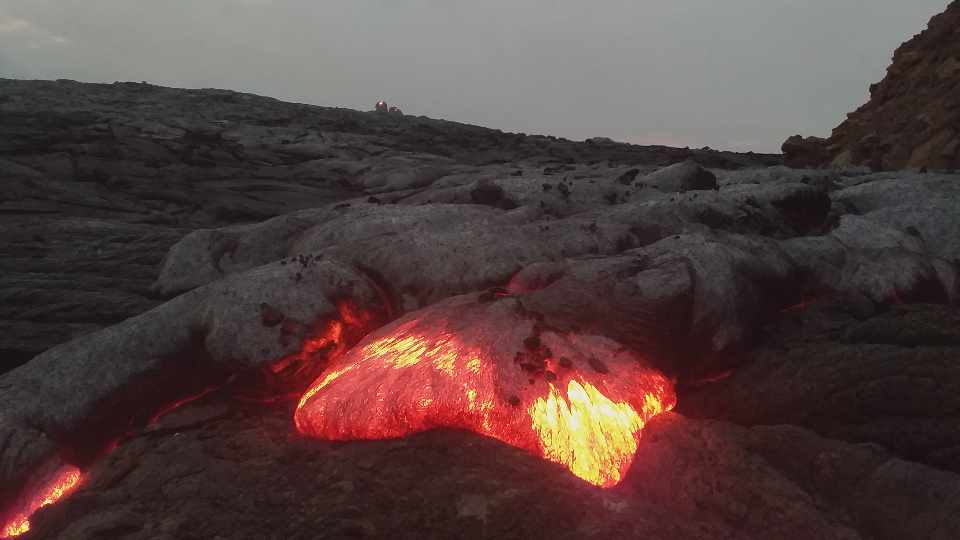 Pahoehoe-type basaltic lava flows effusing from the hornito (in the background) within the southern pit crater (image: Enku Mulugeta/VolcanoDiscovery Ethiopia)