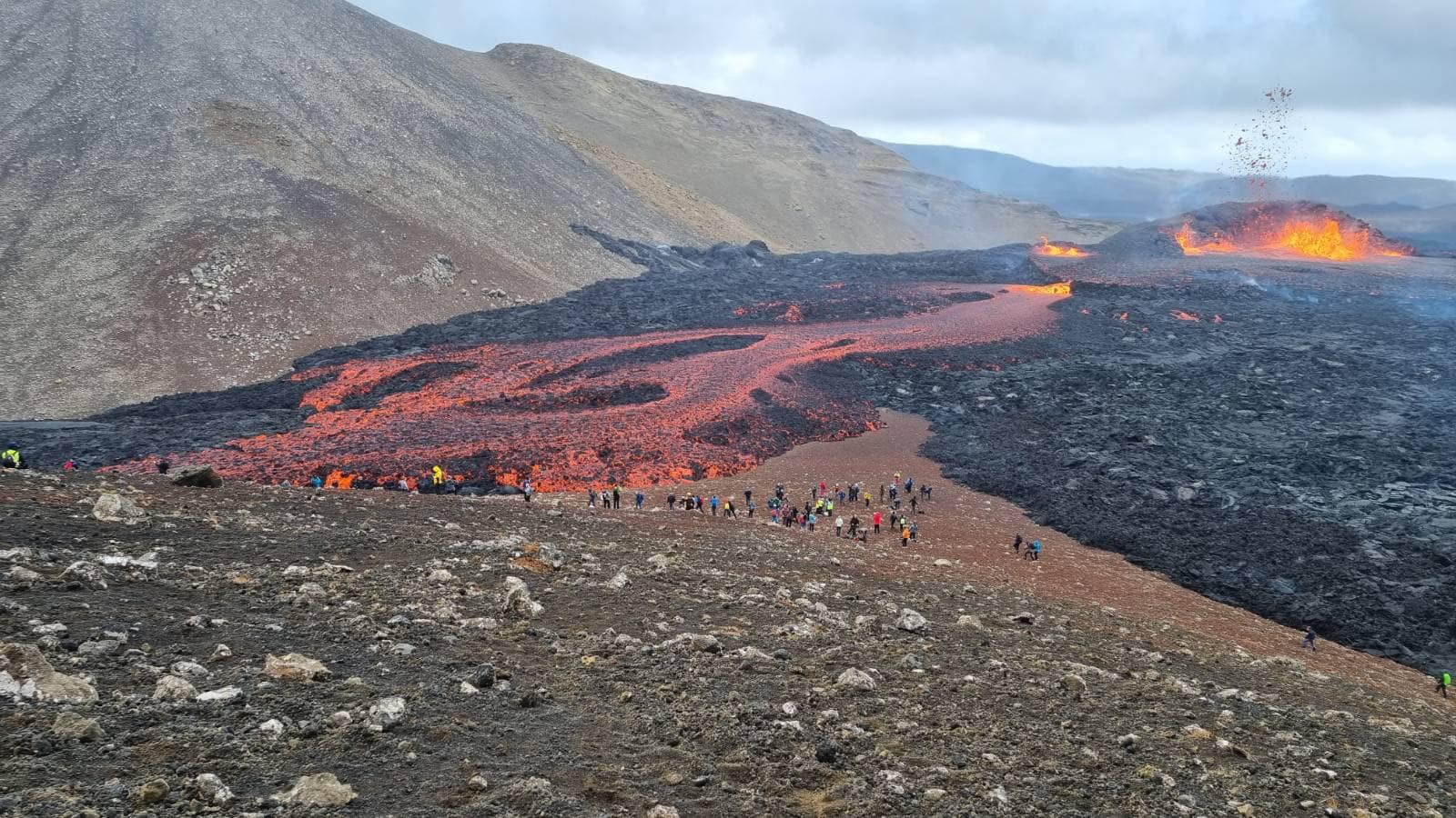 Flowing lava with the erupting spatter cone in the background (image: almannavarnir)