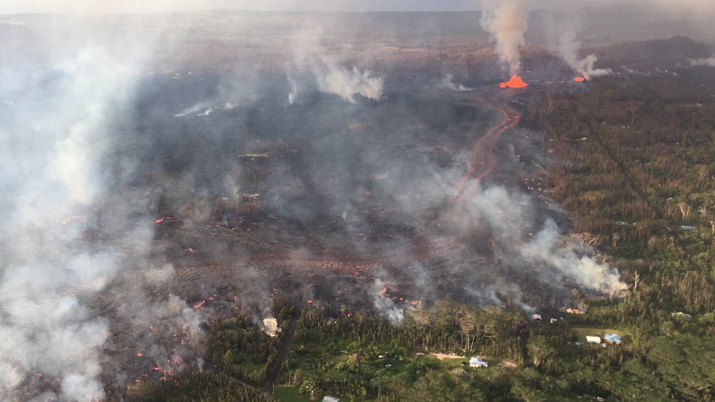 Close view of the lava channel in the middle of the lava flow erupting from fissure 8 during an HVO overflight at about 7 a.m. Monday 28 May. The tallest lava fountain in the photo is fissure 8 which was active since the evening before but who’s eruption diminished significantly later that same morning. (HVO/USGS)