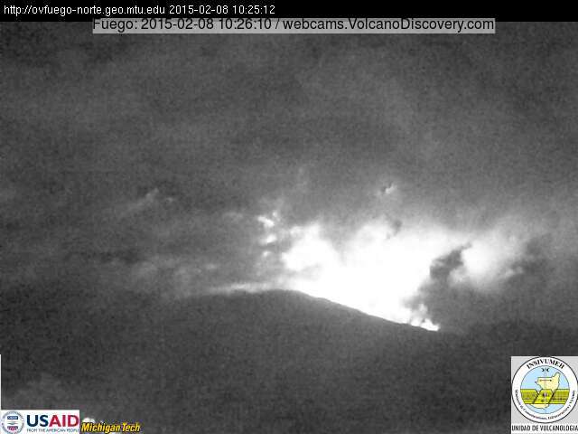 Bright glow at Fuego volcano from violent strombolian activity, lava flows and forest fires