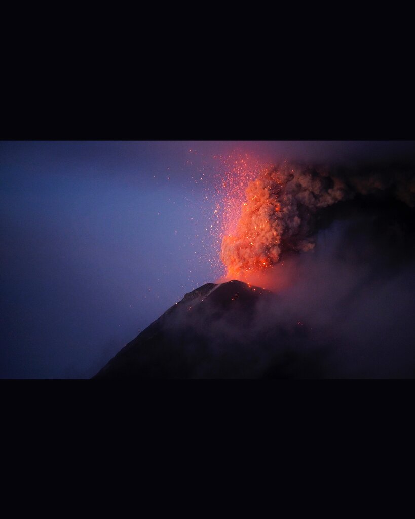 View of Fuego volcano this morning with bright glow from the lava flows