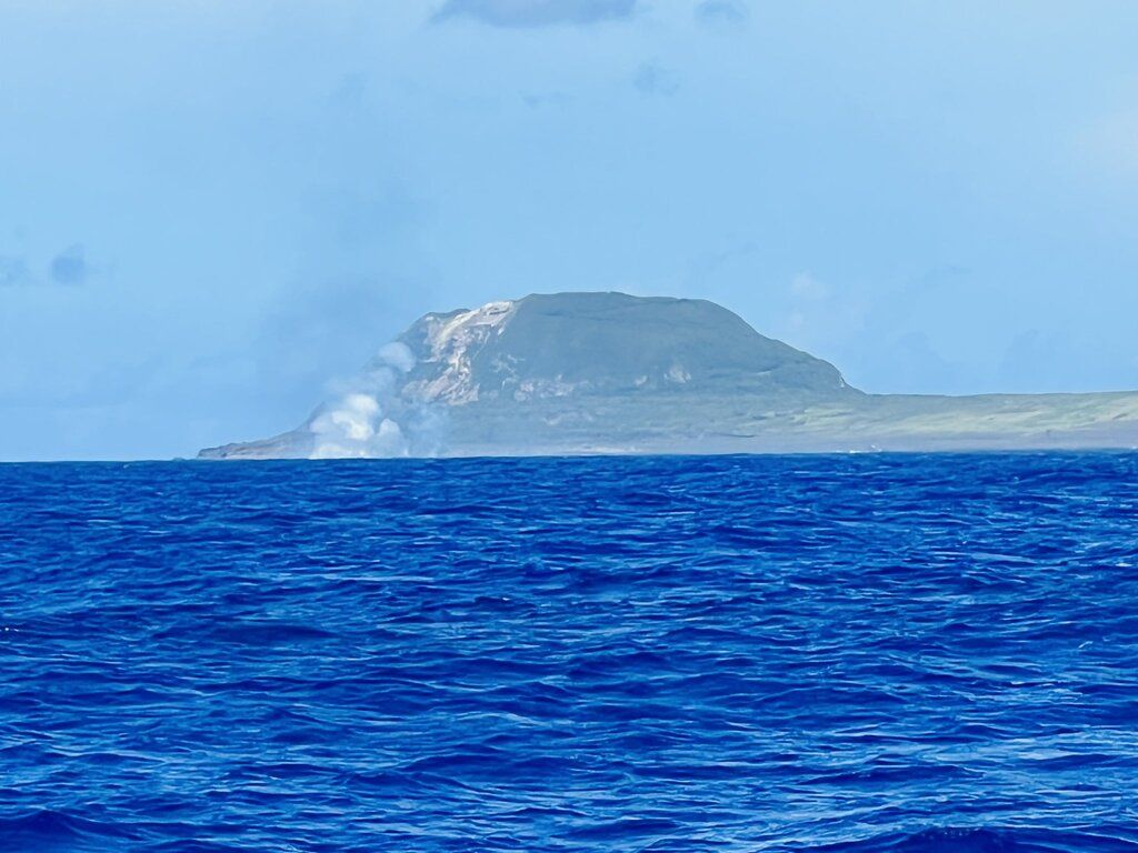 White gas and steam plume visible from a boat