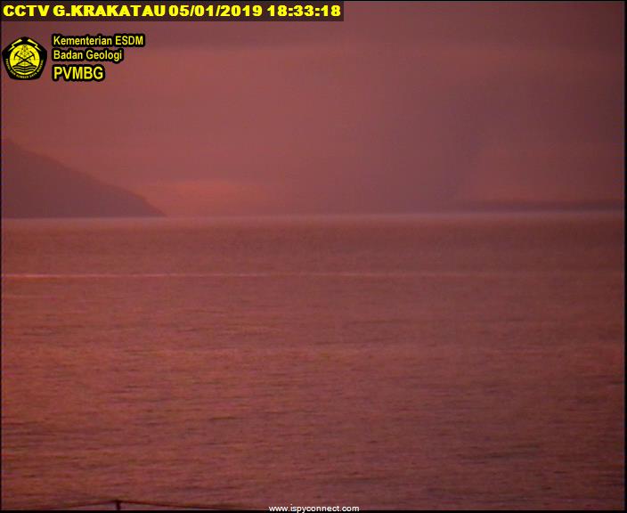 Krakatoa seen this afternoon at sunset - the plume from Anak Krakatau is visible as a dark looming shadow (image: VSI webcam)
