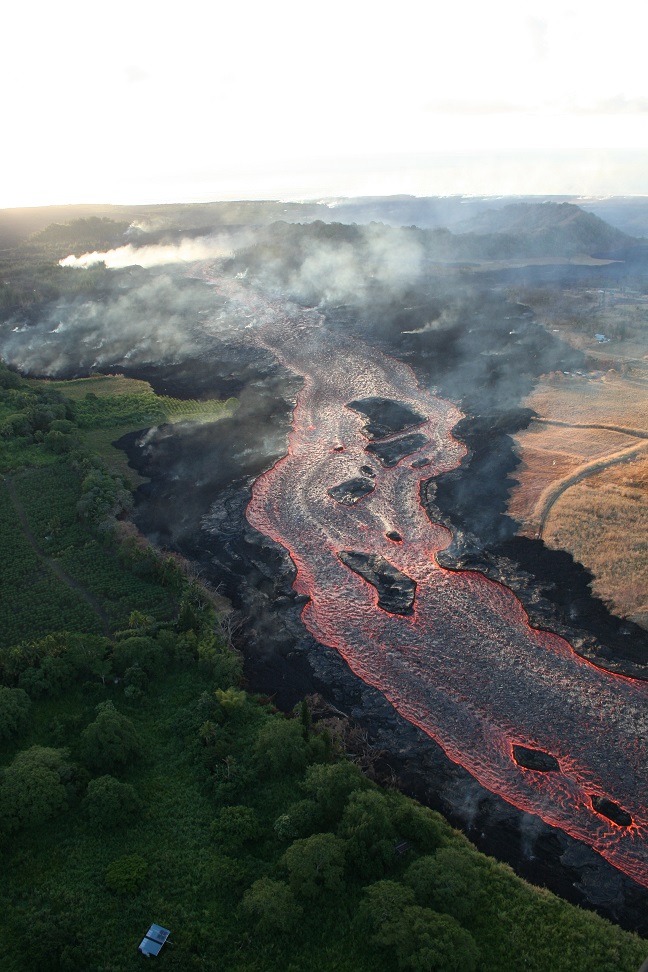 Lava from fissure 8 travels about 13 km (8 mi) to the ocean in an open channel. Lava remains incandescent (glowing orange) throughout its journey. The ocean entry is at upper right. (HVO/USGS)