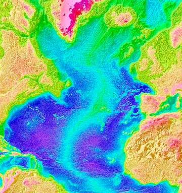 The extensive mid-Atlantic ridge is colour-coded in this image for topography. Warm colours (yellow to red) are at higher elevations than the cooler colours (green to blue). The ridge crest increases in elevation toward Iceland, which is thought to be a hotspot underlain by a plume of hot mantle. The hot mantle thus powers abundant volcanism at Iceland and provides thermal bouyancy for the northern ridge segment (courtesy of NOAA).