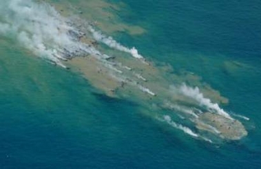 Press photos distributed by the Japanese Coast Guard, showing the site of a probable undersea eruption of Futuku-okanoba submarine volcano on 3 July 2005. Note the discoloration of the sea-water, as well as floating peices of steaming lava blocks on the surface.