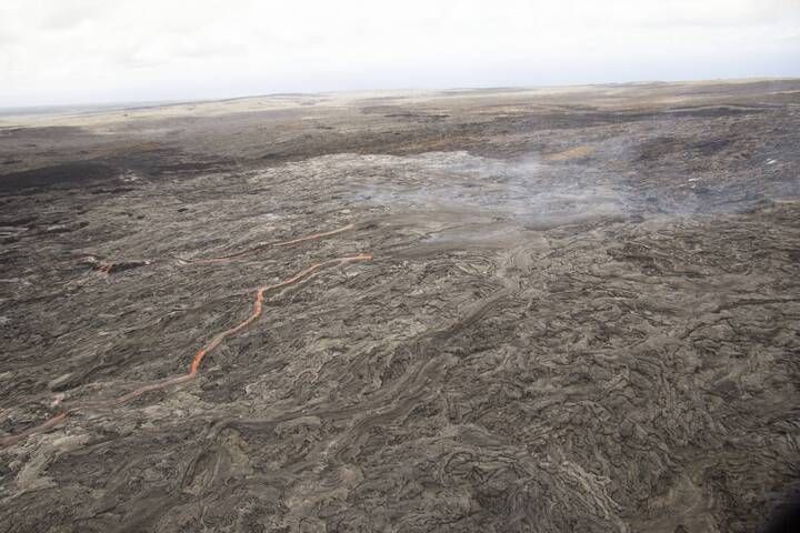 Another look at the lava shield formed from lava erupting from the June 27 vent. The shield consists of a broad, and relatively flat, top with multiple narrow streams of lava flowing down the sides.