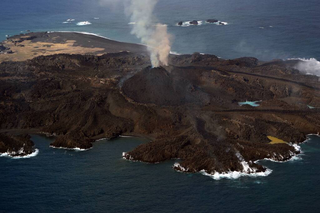 Part of Nishino-shima island with active flows on the southern shore, forming new bays and a small lake that once was a bay (Japan Coast guard)