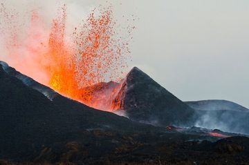 Lava fountain and the active lava flow emerging from the breach of the erupting flank cone of Nyamuragira volcano (8 Jan 2012)