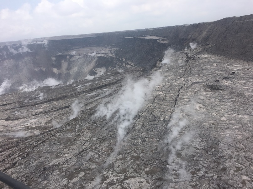 This overflight image of Kīlauea's summit , taken on June 18,  shows the continued dramatic slumping and collapse of the Halema‘uma‘u crater area. The photo shows the area north-northwest of Halema‘uma‘u near a GPS station, North Pit, that has subsided about 60 m (197 ft) in the past week alone. (HVO/USGS)