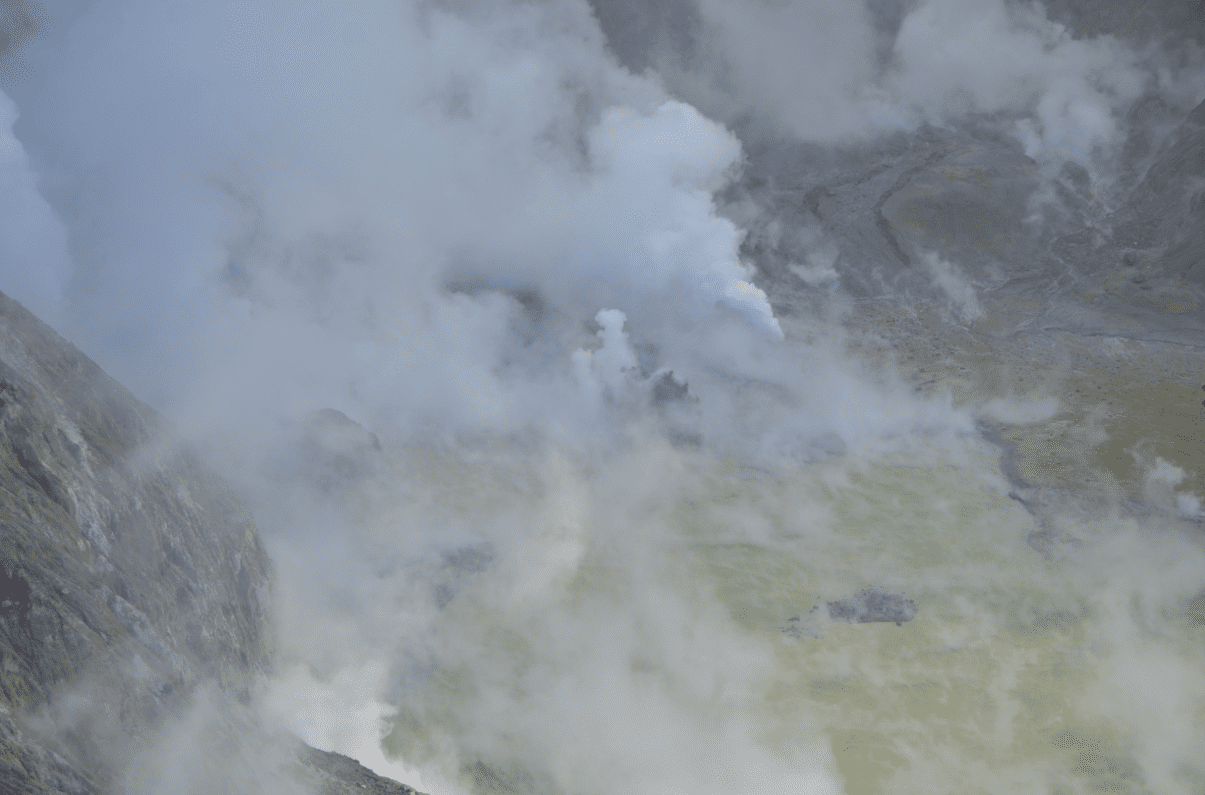 An aerial view into the crater at the White Island volcano on 24 May showing geysering, ejecting steam and dark material (image: Brad Scott/GNS Science)