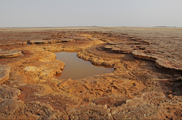 One of many small acid pools amidst the red-brownish layers of salt deposits (Jay Ramji - February 2016)