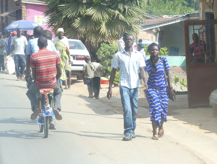 Hustle and bustle of Kigali city with many bike taxis and pedestrians