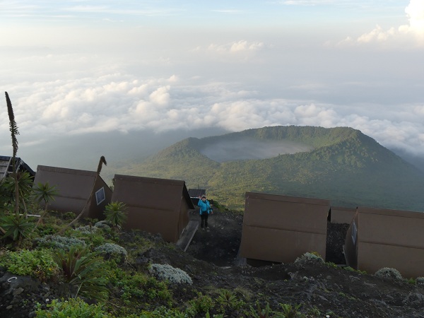 Some of the campsite huts with Shaheru crater in the background