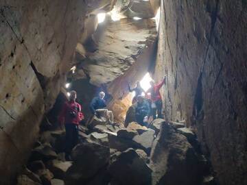 Group inside a natural cave inside the historic lava dome on Methana
